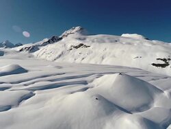 Aerieal view of skiers crossing a glacier in Alaska Stock Footage