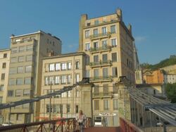 Man walking over bridge  with newspaper with Views of Vieux Lyon along the River Saone, Stock Footage