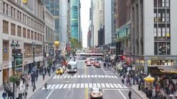 Pedestrians walk across a crosswalk on 42nd Street in New York City. Stock Footage