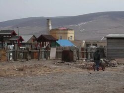 MS Man pushing wheelbarrel to dumpsite in small town / UlaanBaatar, Mongolia, Mongolia Stock Footage