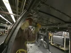 MS PAN Man tightening bolts as part of installation of lift gate on mini van / Princeton, Indiana, United States Stock Footage