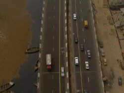 WS AERIAL Shot of freeway near by lagoon with sun effect / Lagos, Nigeria Stock Footage