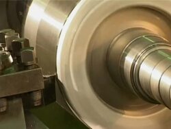 Machine cutting through metal roller Stock Footage