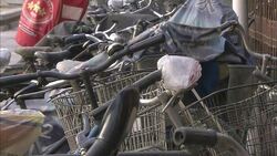 Cloth covers protect parked bicycles Stock Footage