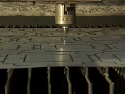 Laser cutting shapes out of a piece of  Stock Footage