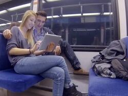 Young adults riding subway and playing with tablet Stock Footage