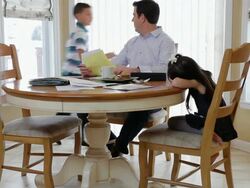  MS Father doing work at home daughter sitting on chair with him and son running around them / Albany, New York   United States   Stock Footage