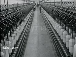 1963: TEXTILES: FABRIC MILL:  LS Open row w/ thread machines both sides, thread machines working. Unusual circular thread machine turning in factory. Instructional Video