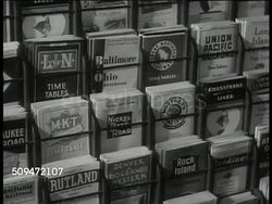 1936: U.S. RAIL ROAD: CU Survey 'Government Ownership of the Railroads...' MS Time table schedule pamphlets on rack. HA MS Streamline train passing. INT Passengers riding in dining car. Franklin Roosevelt's New Deal Instructional Video