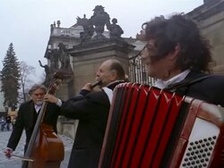 Medium shot trio of muscians performing on the street / Prague Stock Footage