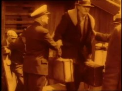 Immigrants disembark with their luggage on Ellis Island. News Clip