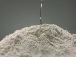 CU SLO MO Egg yoke falling in flour Stock Footage