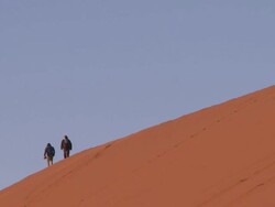 People walking on large sand dune, pull out, Sossusvlei, Namib-Naukluft, Namibia Stock Footage