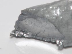 Cutting potassium metal with a scalpel. The shiny exposed metal surface reacts rapidly with oxygen and water in the air, forming a duller layer of potassium oxide and hydroxide Stock Footage
