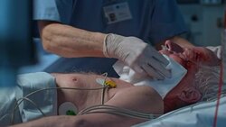 DS Nurse bathing a senior patient lying in ICU Stock Footage