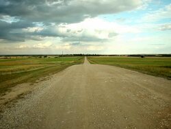 A road that cross near field in the prairies Stock Footage