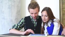 Happy couple with tablet computer sitting in cafe Stock Footage