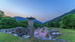 Day and night view of standing stone statue and five-story stone pagoda(Korea treasure) in Mireukdaewonji(Korea historic place) Stock Footage