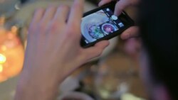 Young man takes a photo of his plate in restaurant and shares with friend Stock Footage