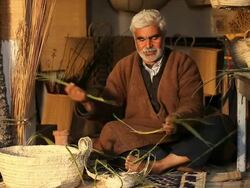 Tunisian Basket Maker weaves basket in traditional way Stock Footage