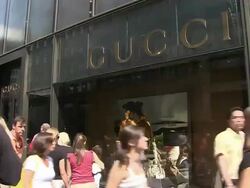 MS, Pedestrians passing by Gucci store window display, Fifth Avenue, New York City, New York, USA Stock Footage