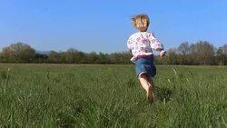 HD Super Slow-Mo: Little Girl Running In The Grass Stock Footage