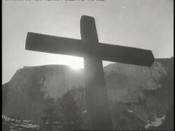 A priest conducts an Easter service by a mountain lake. News Clip