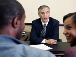 Couple talking with bank manager in bank Stock Footage