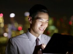 CU Young businessman working on a digital tablet at night. Stock Footage