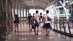 Anonymous crowd walking on sidewalk Stock Footage