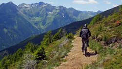 Mountain Biker Riding In Alpine Landscape (UHD) Stock Footage