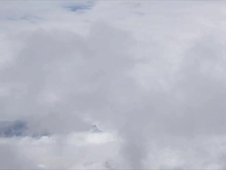 T/L Thorung La above swirling clouds, Himalayas Stock Footage