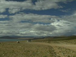 Wide Shot Car heading towards Mansarovar Lake Lhasa Tibet China Stock Footage