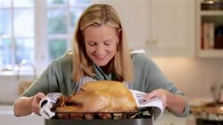 Housewife lifts turkey and smells Stock Footage