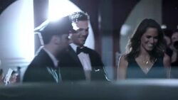 Celebrity couple leaving awards show wave to fans on red carpet at awards show Stock Footage