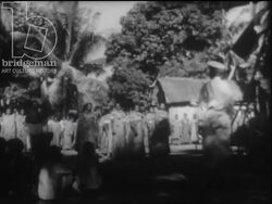 Madagascar c.1958 - Villagers prepare coconuts. Women sing and dance. Stock Footage