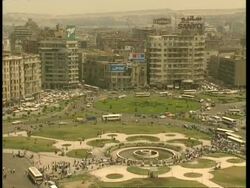 WA High angle view, across bustling city, Park in foreground leading to traffic and high-rise buildings, Egypt Stock Footage