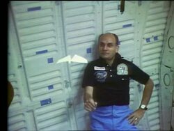 Astronaut Jake Garn playing with paper airplane in Space Shuttle Discovery Stock Footage