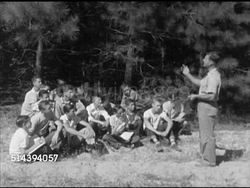 1952: LANEBURG HIGH SCHOOL FOREST: VS Laneburg H.S. students sitting on forest clearing w/ instructor Vance Beasley standing, talking about distinction between two types of pine trees (SOT). Arkansas, AR, Nevada County Instructional Video