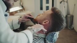 Barber cutting beard Stock Footage