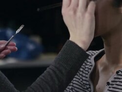 CU PAN Female make-up artist backstage at fashion show applying make-up  Stock Footage