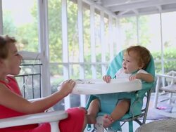MS Shot of young girl feeding her baby brother / St Simon's Island, Georgia, United States Stock Footage