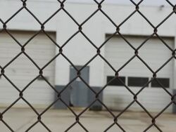 Locked Gate in front of Closed Factory Stock Footage