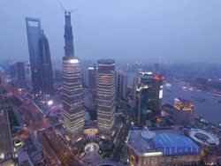 Aerial Timelapse Shanghai - Day to Night  from Pearl TowerPudong, Huangpu River, Jin Mao Tower, Shanghai International Finance Centre, Shanghai World Financial Center, day to night, skyline, city lights, streets, traffic,  China Stock Footage