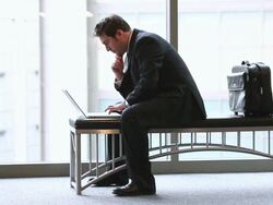  WS Businessman straddling bench and working on laptop computer / Seattle, Washington, United States Stock Footage