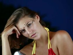 CU Female model in bikini on motorcycle with facial jewelry and twilight sky/ Montezuma, Punteranes, Costa Rica Stock Footage