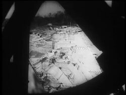 B/W 1930s high angle long shot dam construction site / obstruction in foreground / Tennessee River Valley Stock Footage