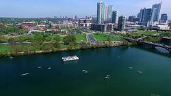 Flying over the Middle of Lake Aerial View Austin Texas Colorado River Fun Spring water activities with kayakers and Party Boat during SXSW Spring Break 2016 with Cityscape Skyline Downtown background Stock Footage