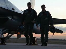MS F-16 Pilots walking next to an F-16 fighter jet at sunset, Aurora, Colorado, USA Stock Footage