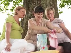 HD DOLLY: Pregnant Friends Showing New Baby Clothes Stock Footage